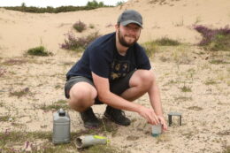 Calum Maclure from the James Hutton Institute setting a pitfall trap for a beetle survey on the Hinterland in early July.