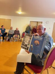 Jonathan Caddy receives a certificate as he steps down as FHT Chair